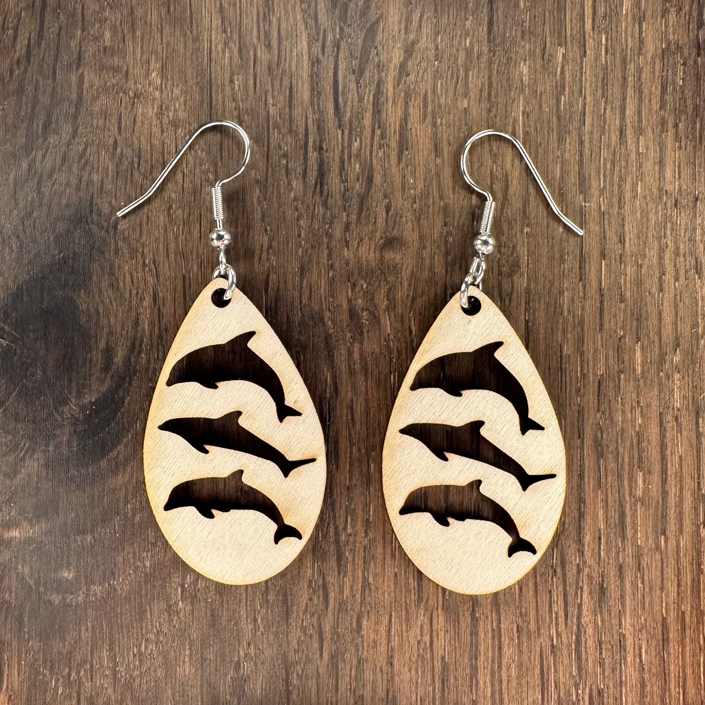 Made in Brisbane, Australia. 40mm long. Triple Dolphin teardrop wooden earrings on stainless steel hooks.